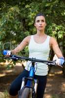 Concentrated woman posing with her bike