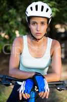 Woman unsmiling posing with her bike