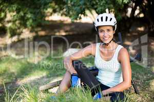 Woman smiling and sitting on the grass