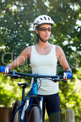 Woman unsmiling posing with her bike