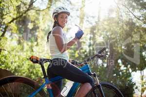 Woman smiling and posing with her bike