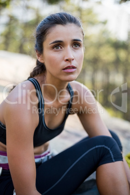 Portrait of woman looking up with climbing equipment