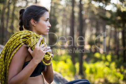 Woman sitting with climbing equipment