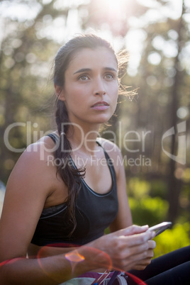 Woman sitting with climbing equipment