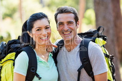 Couple smiling and posing with backpacks