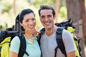 Couple smiling and posing with backpacks