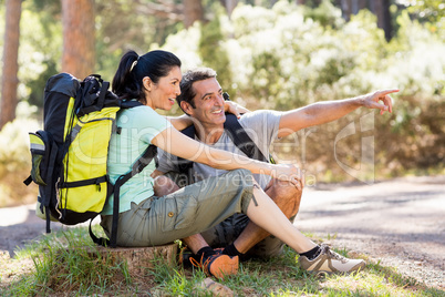 Couple sitting and pointing