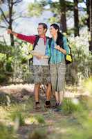 Couple pointing and holding a map