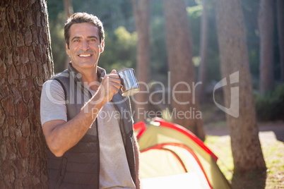 Man smiling and holding cup