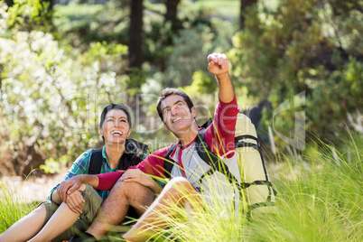 Couple sitting and pointing