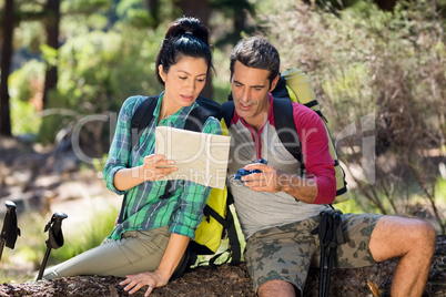 couple hiker studying map and compass