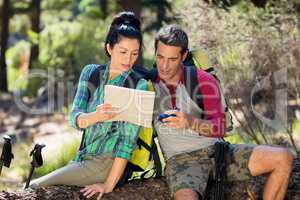 couple hiker studying map and compass