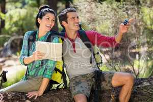 couple smiling and holding map and compass