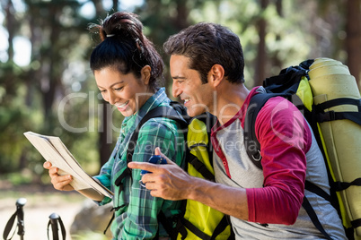 couple hiker studying map and compass