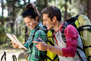 couple hiker studying map and compass