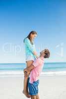 Happy couple posing on the beach