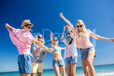 Friends  dancing on the beach