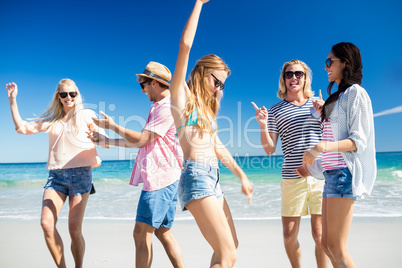 Friends  dancing on the beach