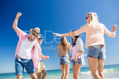 Friends  dancing on the beach