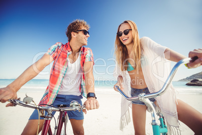 Couple posing with bike on the beach