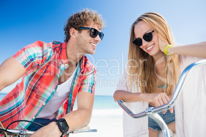 Couple posing with bike on the beach