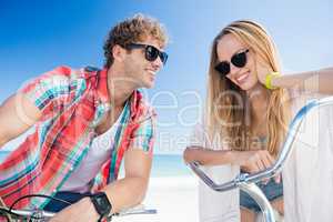 Couple posing with bike on the beach