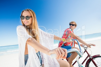 Couple posing with bike on the beach