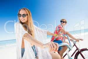 Couple posing with bike on the beach