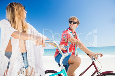 Couple posing with bike on the beach