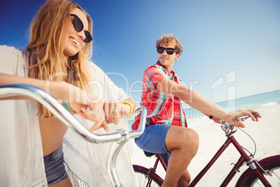 Couple posing with bike on the beach