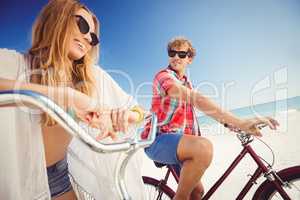 Couple posing with bike on the beach