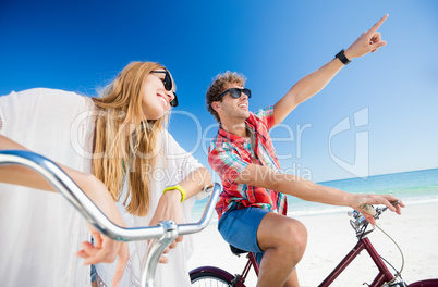 Couple posing with bike on the beach