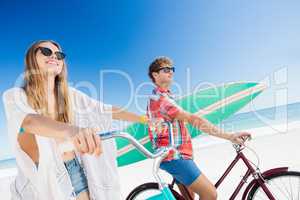 Couple posing with bike on the beach