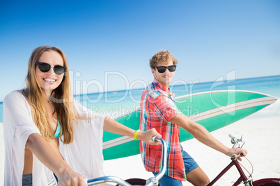 Couple posing with bike on the beach