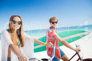 Couple posing with bike on the beach