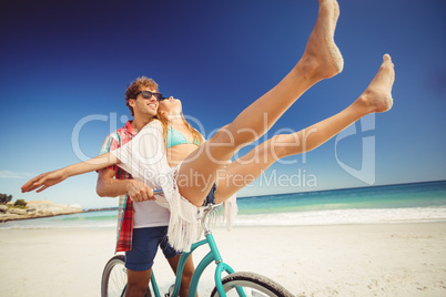 Couple posing with bike on the beach