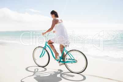 Carefree woman going on a bike ride