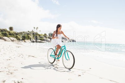 Carefree woman going on a bike ride