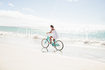 Carefree woman going on a bike ride