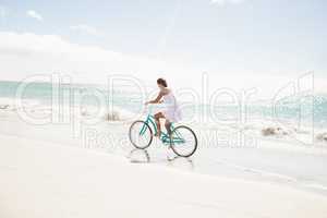 Carefree woman going on a bike ride