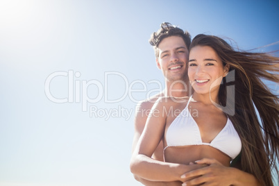 Low angle view of couple embracing