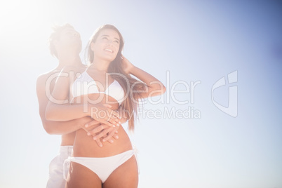 Low angle view of couple embracing