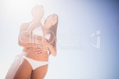 Low angle view of couple embracing