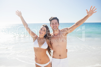 Couple raising their arms