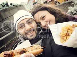 Couple while taking a Selfie eating street food