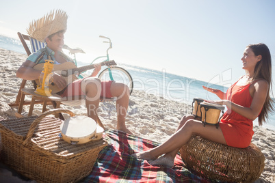 Friends lying and playing music together