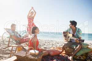 Friends playing the guitar and dancing