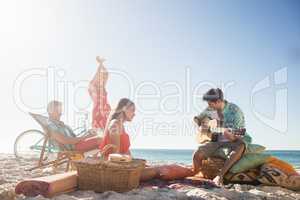 Friends playing the guitar and dancing