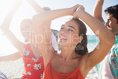 Friends dancing at the beach