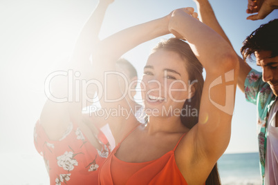 Friends dancing at the beach